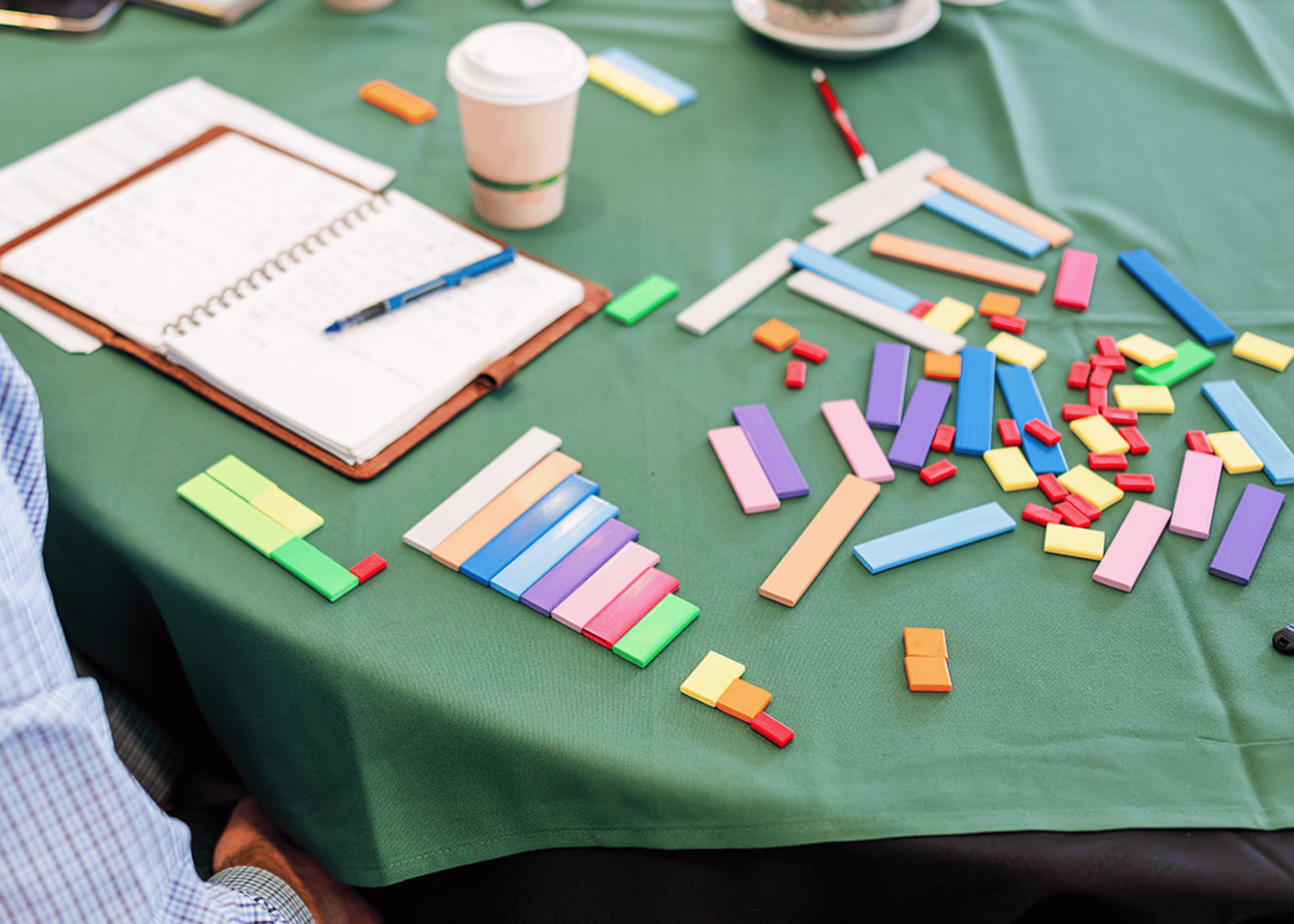 Conference table with notebook and colorful manipulatives